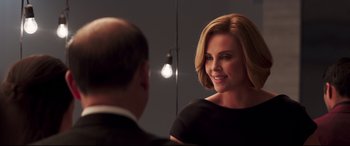 Movie still from “Long Shot” (2019), directed by Jonathan Levine – Charlize theron in front of a mirror in a black dress; Close Up shot, Over the shoulder angle