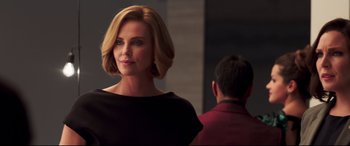 Movie still from “Long Shot” (2019), directed by Jonathan Levine – A woman in a black dress standing in front of a mirror; Close Up shot, Over the shoulder angle