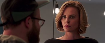 Movie still from “Long Shot” (2019), directed by Jonathan Levine – A man and a woman looking at one another in a room; Close Up shot, Over the shoulder angle