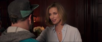 Movie still from “Long Shot” (2019), directed by Jonathan Levine – Charlize theron in a scene from the movie a million ways to die in the west; Close Up shot, Over the shoulder angle