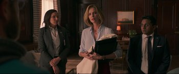 Movie still from “Long Shot” (2019), directed by Jonathan Levine – A woman holding a black bag in front of another woman; Medium shot, Over the shoulder angle