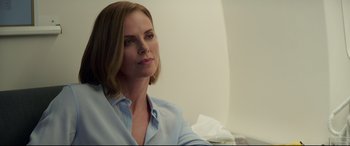 Movie still from “Long Shot” (2019), directed by Jonathan Levine – A woman sitting in front of a white wall; Close Up shot, Over the shoulder angle