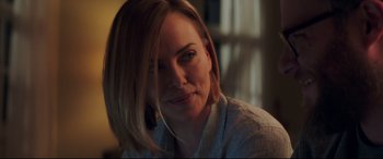 Movie still from “Long Shot” (2019), directed by Jonathan Levine – A person sitting in front of a window; Close Up shot, Over the shoulder angle