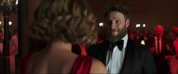 Movie still from “Long Shot” (2019), directed by Jonathan Levine – A man and a woman in formal wear looking at each other; Close Up shot, Over the shoulder angle