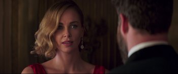Movie still from “Long Shot” (2019), directed by Jonathan Levine – A woman in a red dress looking at a man in a suit; Close Up shot, Over the shoulder angle