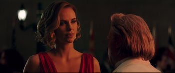 Movie still from “Long Shot” (2019), directed by Jonathan Levine – A woman in a red dress and a man in a white shirt; Close Up shot, Over the shoulder angle