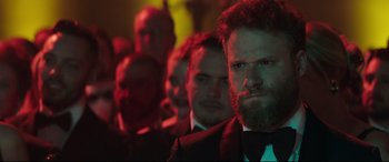Movie still from “Long Shot” (2019), directed by Jonathan Levine – A group of men standing in front of each other; Close Up shot, Over the shoulder angle