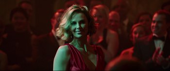 Movie still from “Long Shot” (2019), directed by Jonathan Levine – A beautiful woman in a red dress posing for a picture; Close Up shot, Over the shoulder angle