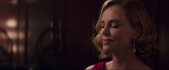 Movie still from “Long Shot” (2019), directed by Jonathan Levine – A woman with her eyes closed with her eyes closed; Close Up shot, Over the shoulder angle