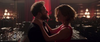 Movie still from “Long Shot” (2019), directed by Jonathan Levine – A man and a woman in a red dress; Medium shot, Over the shoulder angle