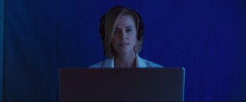 Movie still from “Long Shot” (2019), directed by Jonathan Levine – A woman wearing headphones looking at a computer screen; Close Up shot, Low angle