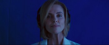 Movie still from “Long Shot” (2019), directed by Jonathan Levine – A woman wearing headphones and looking at the camera; Close Up shot, Low angle