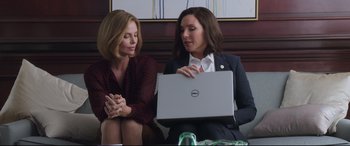 Movie still from “Long Shot” (2019), directed by Jonathan Levine – Two women sitting next to each other holding a laptop; Medium shot, Over the shoulder angle
