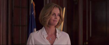 Movie still from “Long Shot” (2019), directed by Jonathan Levine – Charlize theron wearing a white shirt; Close Up shot, Over the shoulder angle