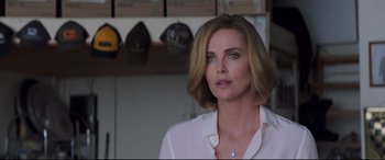 Movie still from “Long Shot” (2019), directed by Jonathan Levine – Charlize theron is wearing a white shirt and necklace; Close Up shot, Over the shoulder angle