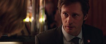 Movie still from “Long Shot” (2019), directed by Jonathan Levine – A person wearing a suit and tie; Close Up shot, Over the shoulder angle