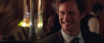 Movie still from “Long Shot” (2019), directed by Jonathan Levine – A person wearing a suit and smiling; Close Up shot, Over the shoulder angle