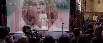 Movie still from “Long Shot” (2019), directed by Jonathan Levine – A woman standing at a podium in front of a crowd; Wide shot, Low angle