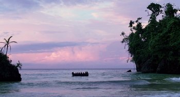 Movie still from “Lord of the Flies” (1990), directed by Harry Hook – A group of people on a raft in the ocean; Extreme Wide shot, High angle
