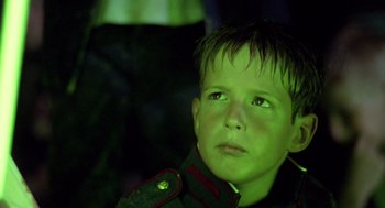 Movie still from “Lord of the Flies” (1990), directed by Harry Hook – A young boy wearing a uniform looking up; Close Up shot, Low angle