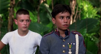 Movie still from “Lord of the Flies” (1990), directed by Harry Hook – Two young men in military uniforms standing next to each other; Close Up shot, Low angle