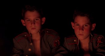 Movie still from “Lord of the Flies” (1990), directed by Harry Hook – Two young men in military uniforms are posing for a picture; Close Up shot, High angle