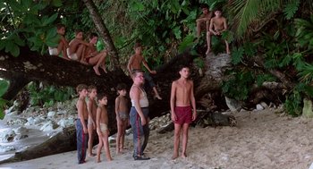 Movie still from “Lord of the Flies” (1990), directed by Harry Hook – A group of young people standing on top of a tree; Wide shot, High angle