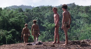Movie still from “Lord of the Flies” (1990), directed by Harry Hook – A group of young men standing next to each other on top of a hill; Wide shot, Low angle