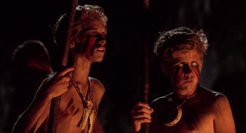 Movie still from “Lord of the Flies” (1990), directed by Harry Hook – A couple of men standing next to each other holding sticks; Close Up shot, Low angle