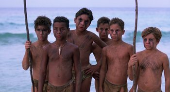 Movie still from “Lord of the Flies” (1990), directed by Harry Hook – A group of young men standing next to each other; Medium shot, High angle