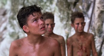 Movie still from “Lord of the Flies” (1990), directed by Harry Hook – A group of young men standing next to each other; Close Up shot, Low angle
