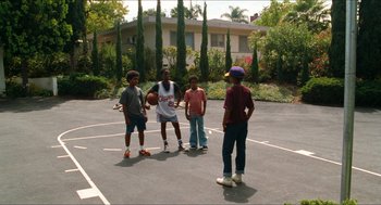 Movie still from “Love & Basketball” (2000), directed by Gina Prince-Bythewood – A group of young men standing on top of a basketball court; Wide shot, High angle