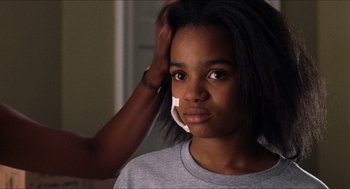 Movie still from “Love & Basketball” (2000), directed by Gina Prince-Bythewood – A young woman with a bandage on her face; Close Up shot, Over the shoulder angle