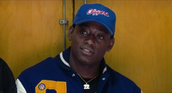 Movie still from “Love & Basketball” (2000), directed by Gina Prince-Bythewood – A person wearing a cap; Close Up shot, Over the shoulder angle