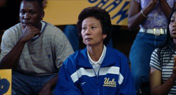 Movie still from “Love & Basketball” (2000), directed by Gina Prince-Bythewood – An older woman in a blue and white jacket; Close Up shot, High angle