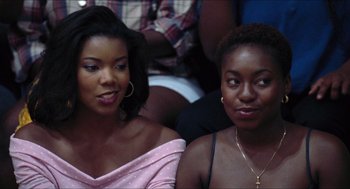 Movie still from “Love & Basketball” (2000), directed by Gina Prince-Bythewood – Two women sitting next to each other in a room; Close Up shot, Over the shoulder angle