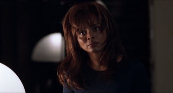 Movie still from “Love & Basketball” (2000), directed by Gina Prince-Bythewood – A person with long brown hair; Close Up shot, Over the shoulder angle