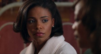 Movie still from “Love & Basketball” (2000), directed by Gina Prince-Bythewood – A person wearing a white coat; Close Up shot, Over the shoulder angle