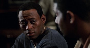 Movie still from “Love & Basketball” (2000), directed by Gina Prince-Bythewood – A person sitting down with another person; Close Up shot, Over the shoulder angle