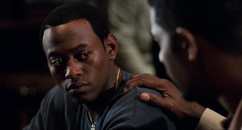 Movie still from “Love & Basketball” (2000), directed by Gina Prince-Bythewood – A young man with his arm around another young man's shoulder; Close Up shot, Over the shoulder angle