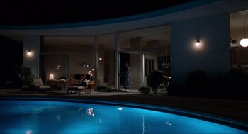Movie still from “Love & Basketball” (2000), directed by Gina Prince-Bythewood – A man standing at the entrance of a house; Extreme Wide shot, High angle