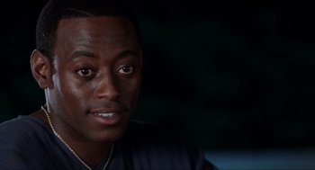 Movie still from “Love & Basketball” (2000), directed by Gina Prince-Bythewood – A person wearing a black shirt; Close Up shot, Over the shoulder angle