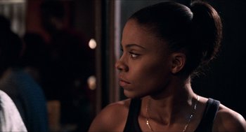 Movie still from “Love & Basketball” (2000), directed by Gina Prince-Bythewood – A beautiful young woman looking off into the distance; Close Up shot, Over the shoulder angle
