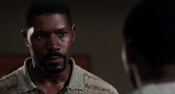 Movie still from “Love & Basketball” (2000), directed by Gina Prince-Bythewood – A person wearing a sweater; Close Up shot, Over the shoulder angle