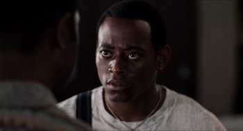 Movie still from “Love & Basketball” (2000), directed by Gina Prince-Bythewood – A person wearing a white t - shirt; Close Up shot, Over the shoulder angle