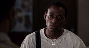 Movie still from “Love & Basketball” (2000), directed by Gina Prince-Bythewood – A person wearing a necklace; Close Up shot, Over the shoulder angle