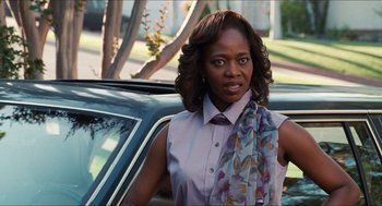 Movie still from “Love & Basketball” (2000), directed by Gina Prince-Bythewood – A woman standing in front of a parked car; Close Up shot, Over the shoulder angle