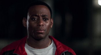 Movie still from “Love & Basketball” (2000), directed by Gina Prince-Bythewood – A person wearing a red jacket; Close Up shot, Low angle