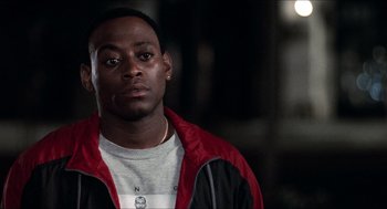 Movie still from “Love & Basketball” (2000), directed by Gina Prince-Bythewood – A person wearing a red and black jacket; Close Up shot, Low angle