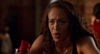 Movie still from “Love & Basketball” (2000), directed by Gina Prince-Bythewood – A person holding a flower; Close Up shot, Over the shoulder angle